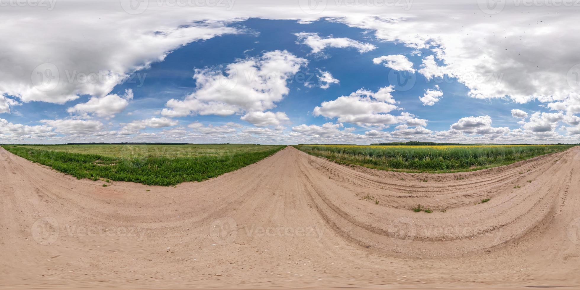 full seamless spherical hdri panorama 360 degrees angle view on gravel road among fields in summer day with awesome clouds in equirectangular projection, for VR AR virtual reality content photo