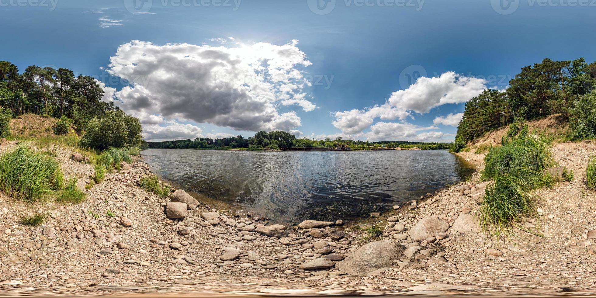 full spherical seamless hdri panorama 360 degrees angle view on rocky shore of huge river in sunny summer day and windy weather with beautiful clouds in equirectangular projection, VR content photo