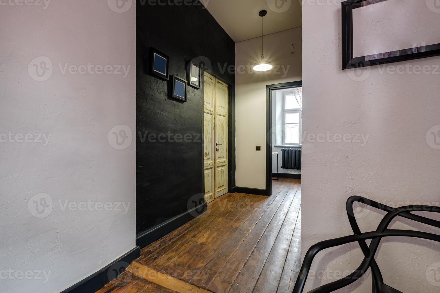 long corridor in interior of entrance hall of vintage apartments with doors in loft interior with brick walls photo