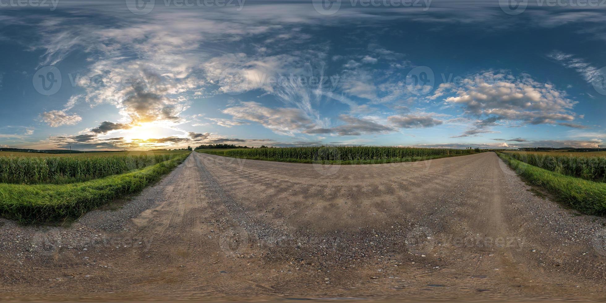 full seamless spherical panorama 360 degrees angle view on gravel road among fields in summer evening sunset with awesome clouds in equirectangular projection, skybox VR AR virtual reality content photo