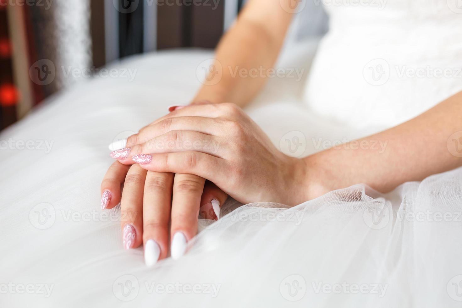 women's hands folded on their knees in anticipation of the wedding and ...