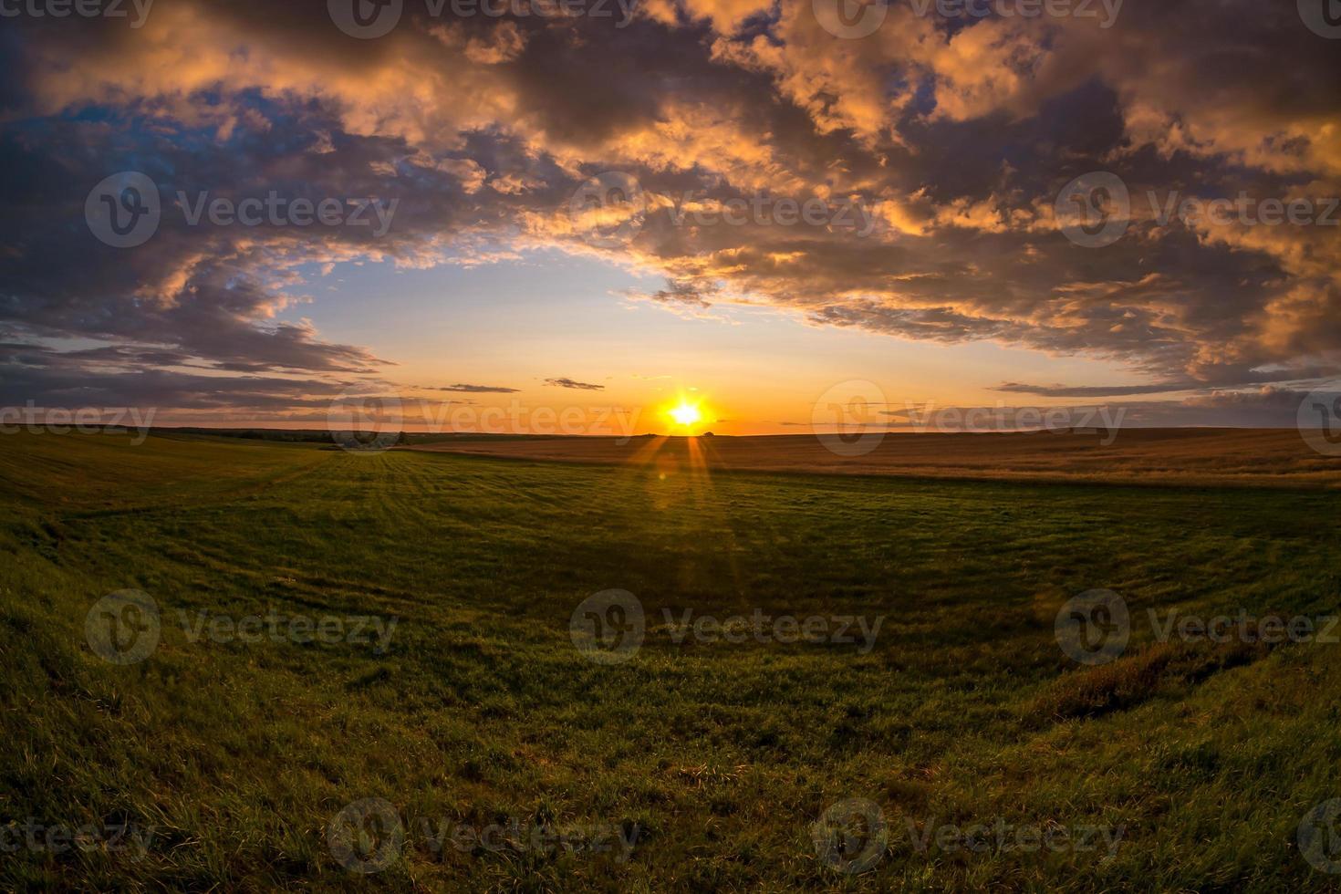 Blue red sky background with evening fluffy curly rolling clouds with setting sun. Good windy weather photo