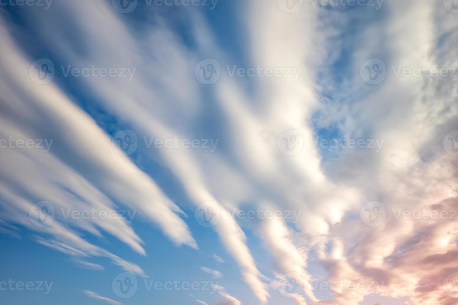 Blue sky background with tiny curly striped clouds in the evening. Clearing day and Good windy weather photo