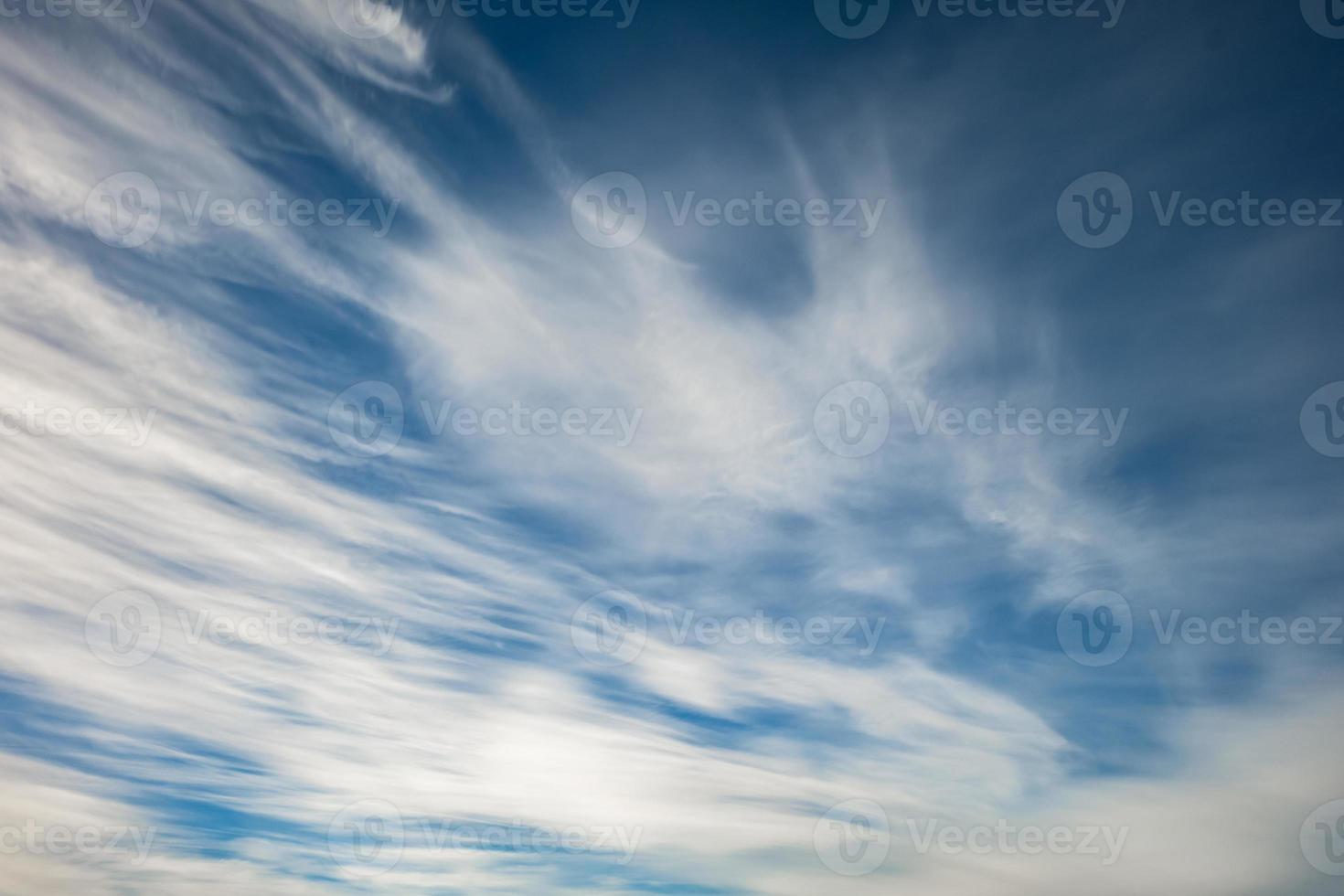 Blue sky background with tiny stratus cirrus striped clouds. Clearing day and Good windy weather photo