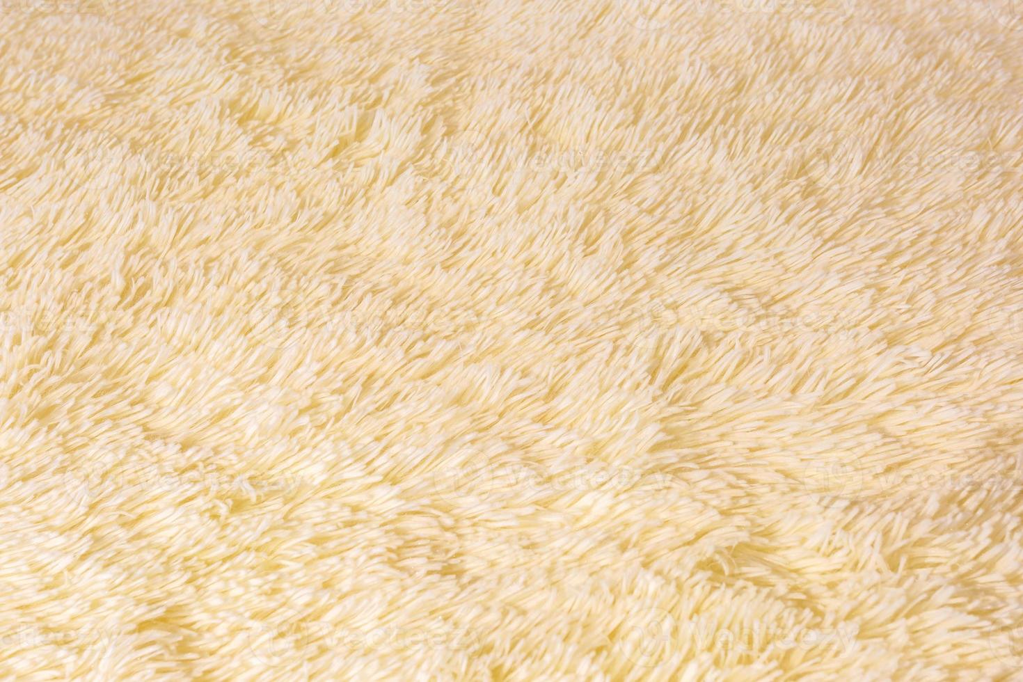Faux fur background texture close-up light color. Artificial fur with short pile blank background photo