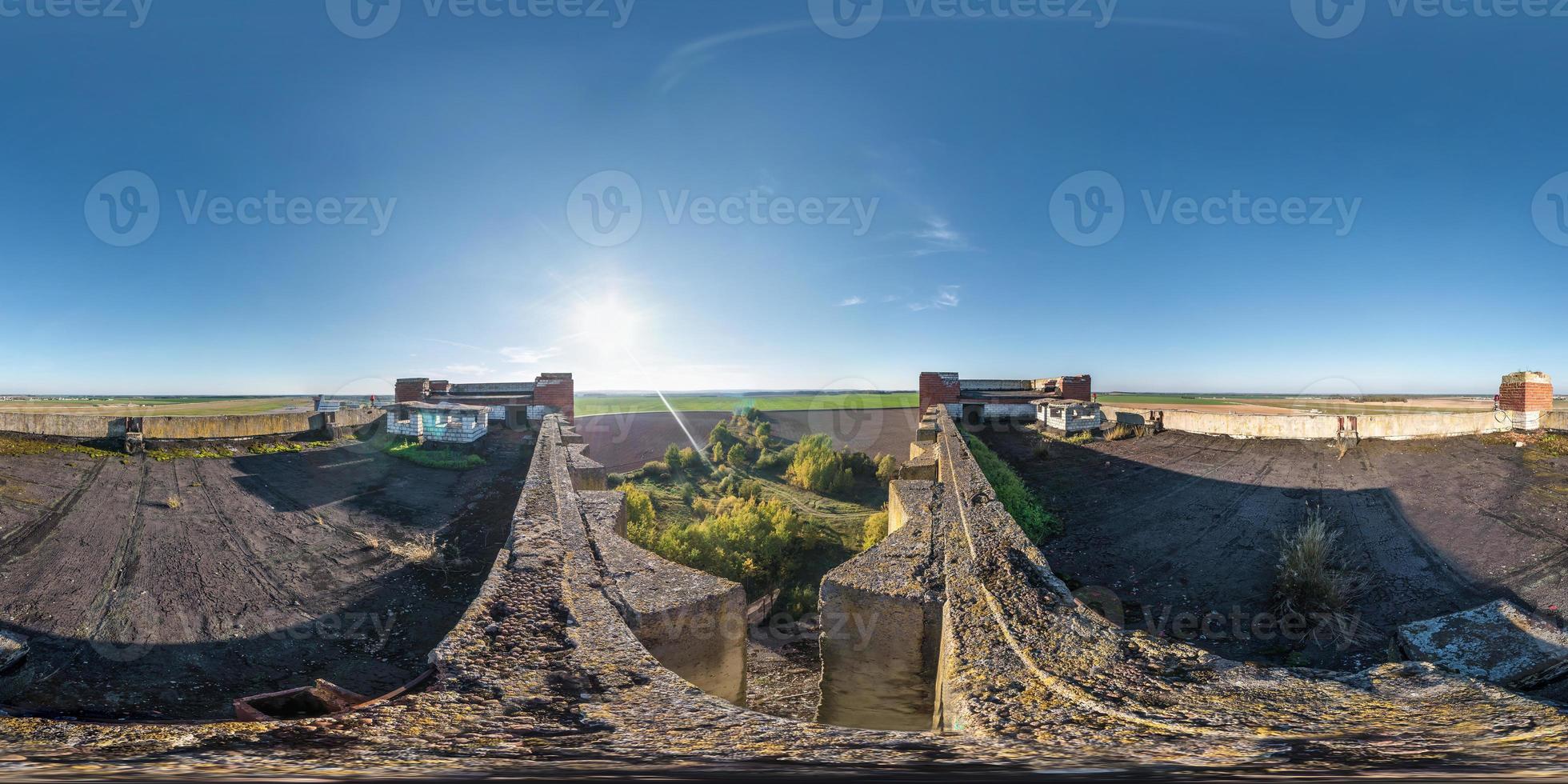 Aerial full spherical seamless panorama 360 degrees angle view with roof concrete abandoned unfinished building. 360 panorama  in equirectangular equidistant projection, VR AR content photo