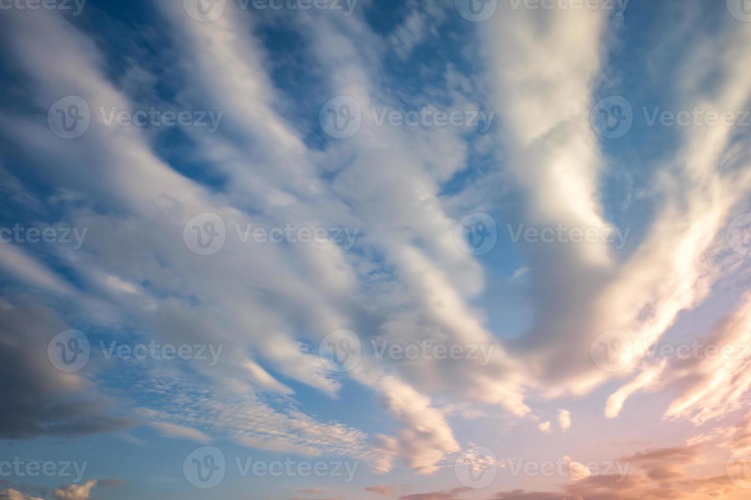 Blue sky background with tiny curly striped clouds in the evening. Clearing day and Good windy weather photo