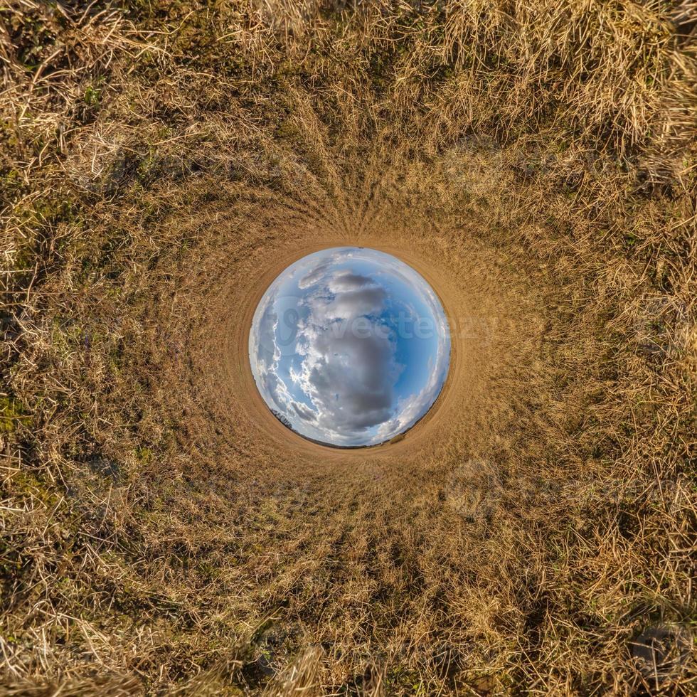 blue sky ball in middle of swirling field. Inversion of tiny planet transformation of spherical panorama 360 degrees. Curvature of space. photo