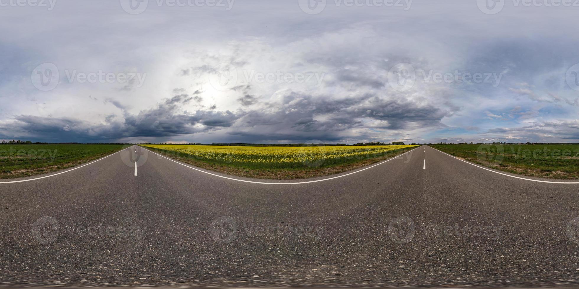 full seamless spherical hdr panorama 360 degrees angle view on asphalt road among fields in evening with awesome black clouds before storm in equirectangular projection, VR AR virtual reality content photo