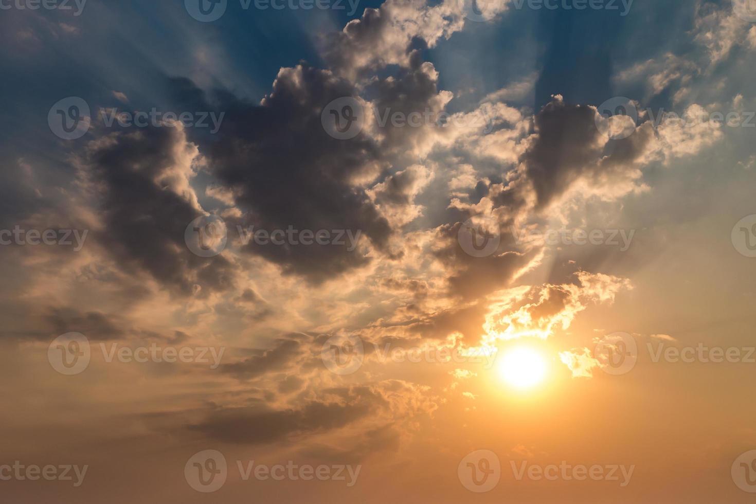 Blue sky background with evening fluffy curly rolling altocumulus altostratus clouds with setting sun. Good windy weather photo