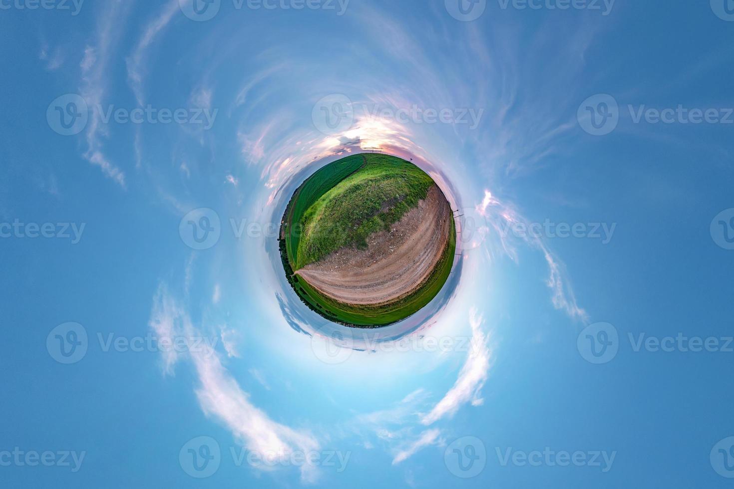 Little planet transformation of spherical panorama 360 degrees. Spherical abstract aerial view in field in nice evening with awesome beautiful clouds. Curvature of space. photo