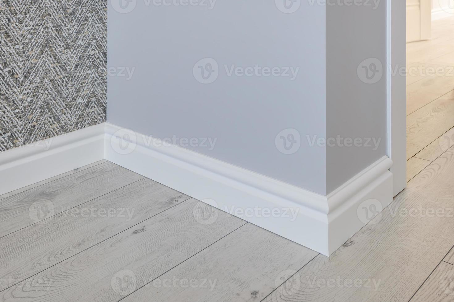 Detail of corner flooring with intricate crown molding and plinth. photo