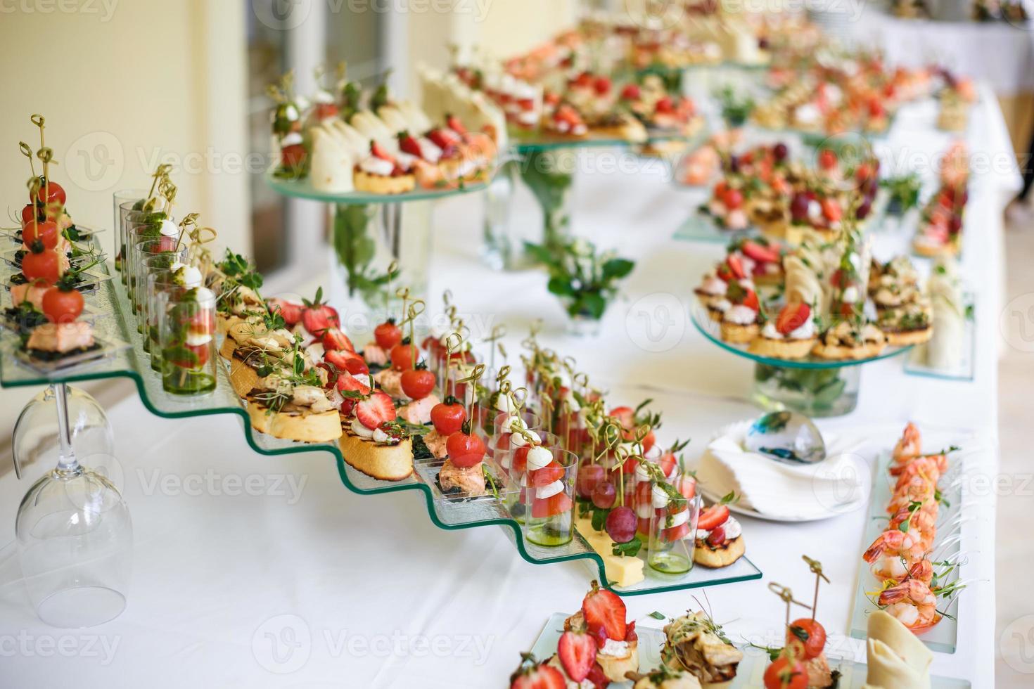 Catering. Off-site food. Buffet table with various canapes, sandwiches, hamburgers and snacks. photo