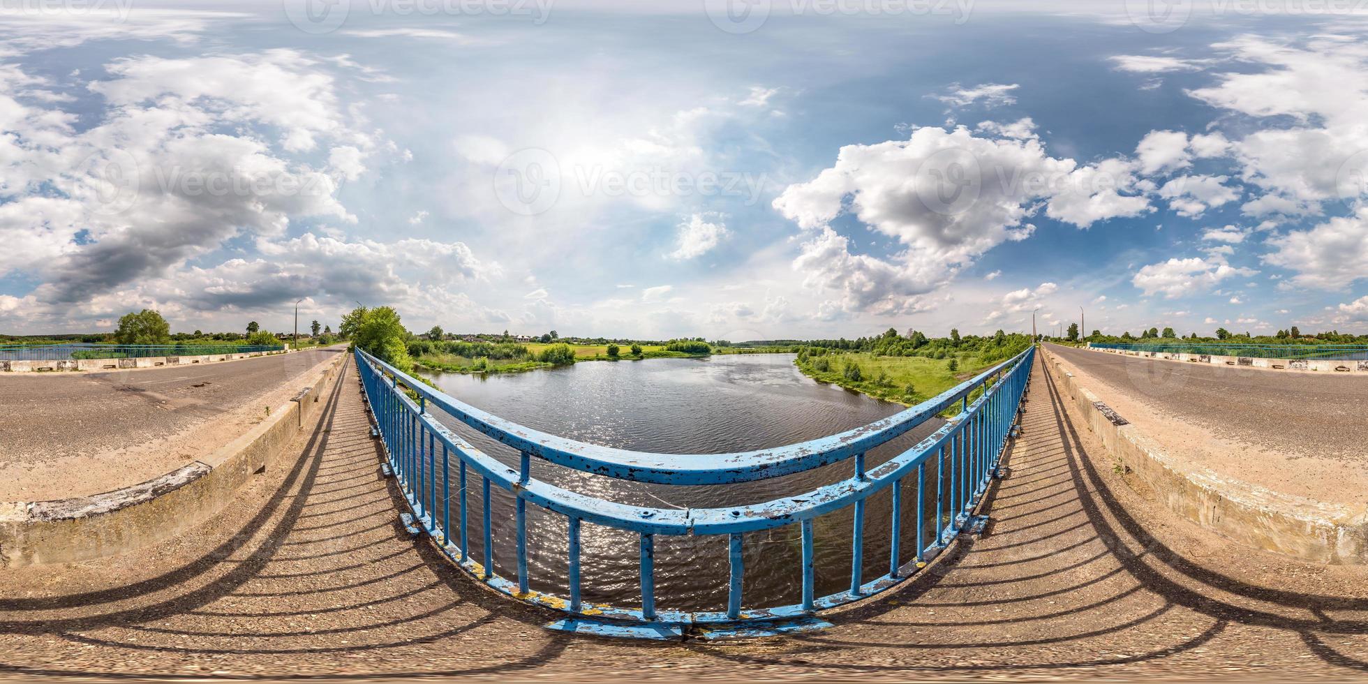 full seamless spherical hdri panorama 360 degrees  angle view on concrete bridge near asphalt road across river in sunny summer day in equirectangular projection, AR VR virtual reality content photo