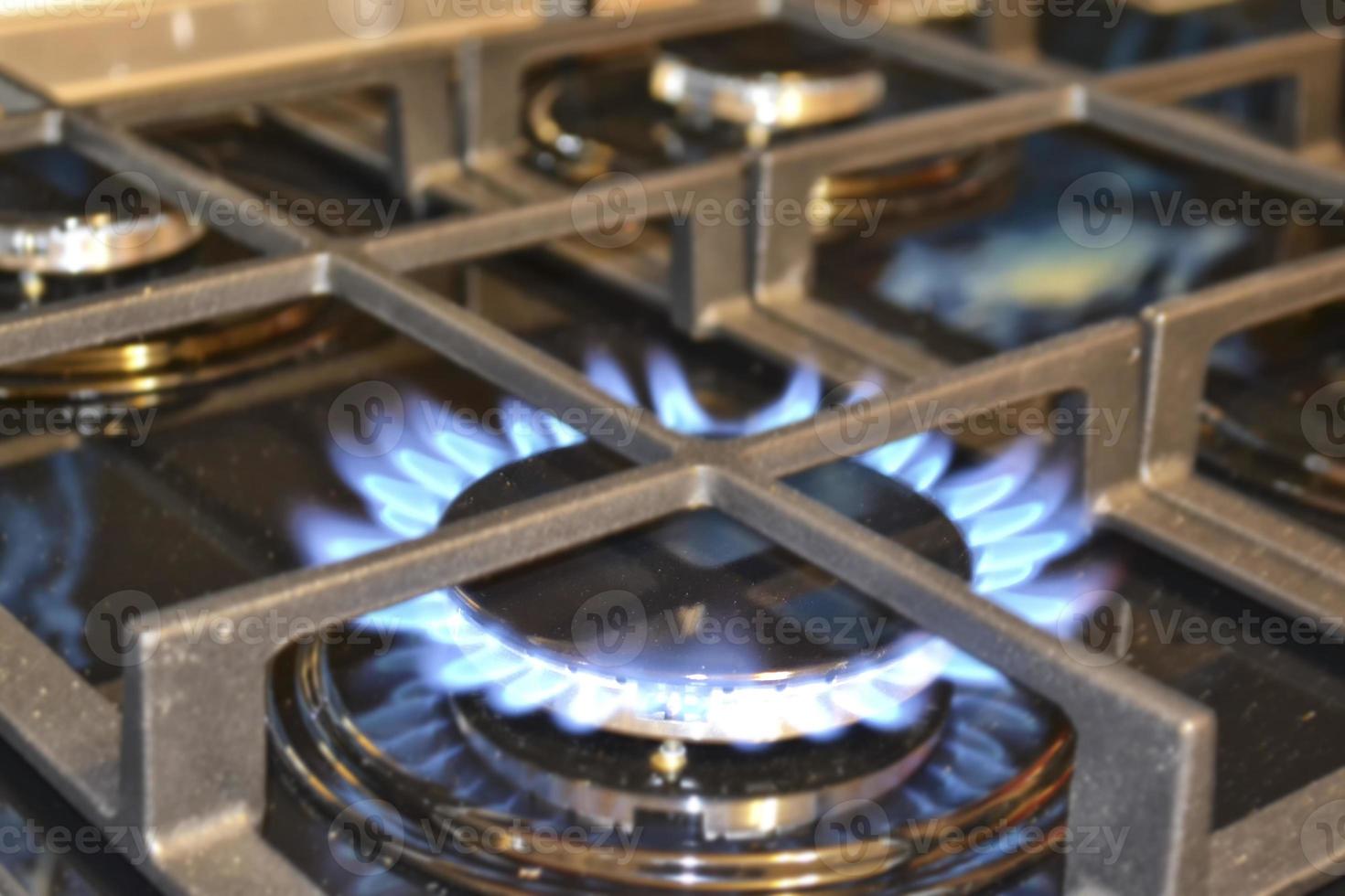 Blurred background. Blue gas flame on the gas stove photo