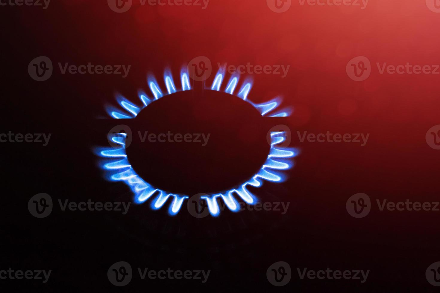 Blurred background. Blue gas flame on the gas stove photo