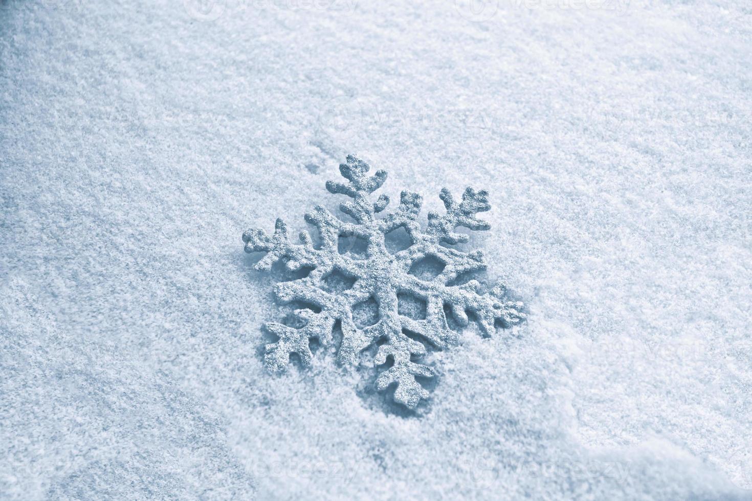 White fluffy snowflakes on snow. Winter christmas background. photo