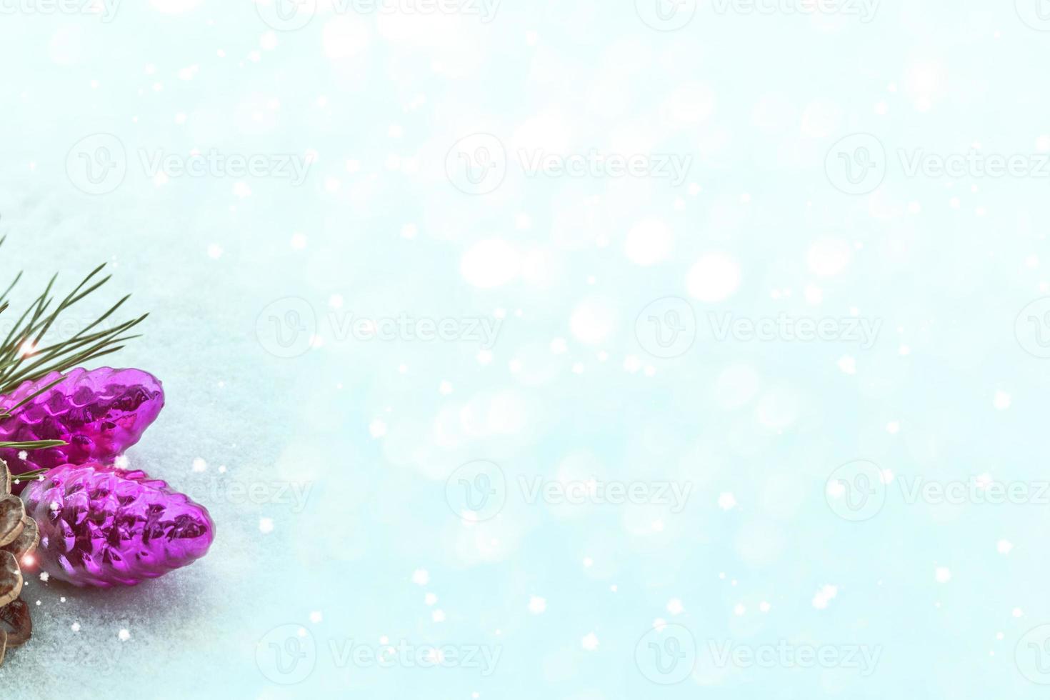 Christmas card. Pine branch and toys on a background of white snow. photo