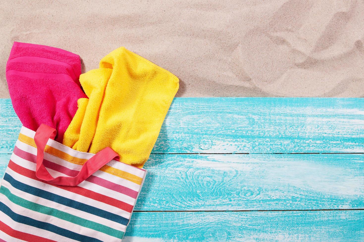 Summer background, summer items on the sand top view - copy space photo