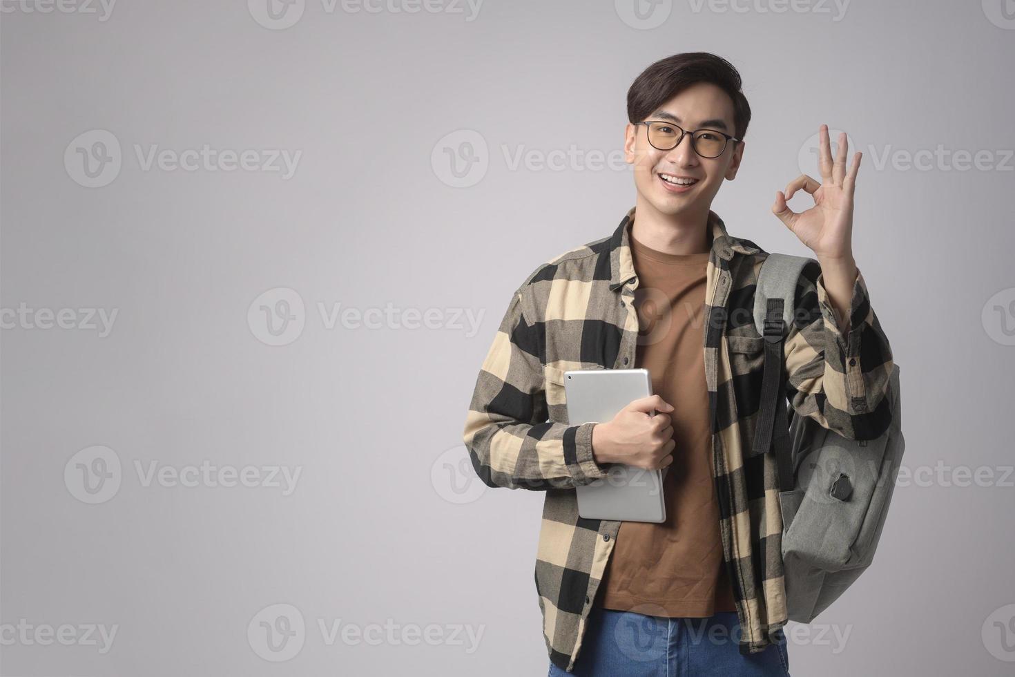 Portrait of an Asian university student over white background studio, education concept. photo