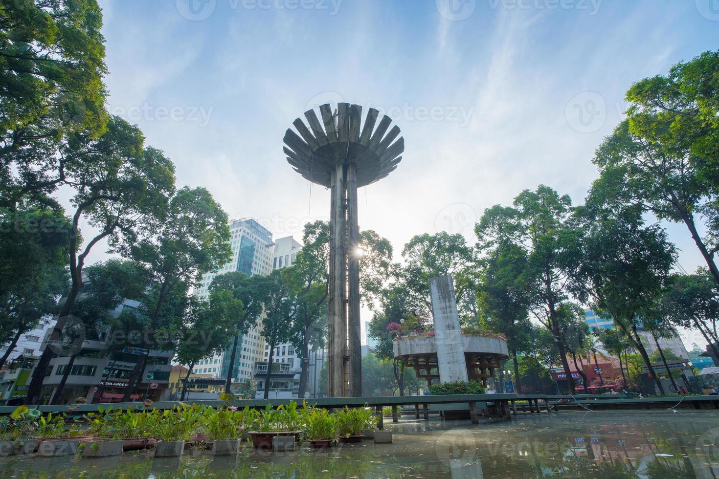 Wide angle view of Lotus pillar - An iconic architecture at Turtle lake , Ho Con Rua with blue sky in Saigon. photo