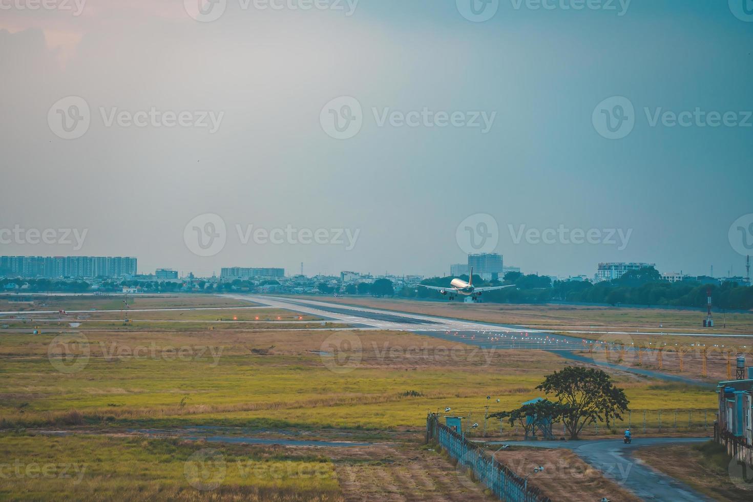 Ho Chi Minh city, Vietnam - FEB 12 2022 Airplane fly over urban areas preparing landing into Tan Son Nhat International Airport and takes off in TSN airport photo