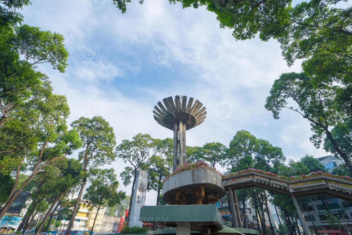 Wide angle view of Lotus pillar - An iconic architecture at Turtle lake , Ho Con Rua with blue sky in Saigon. photo