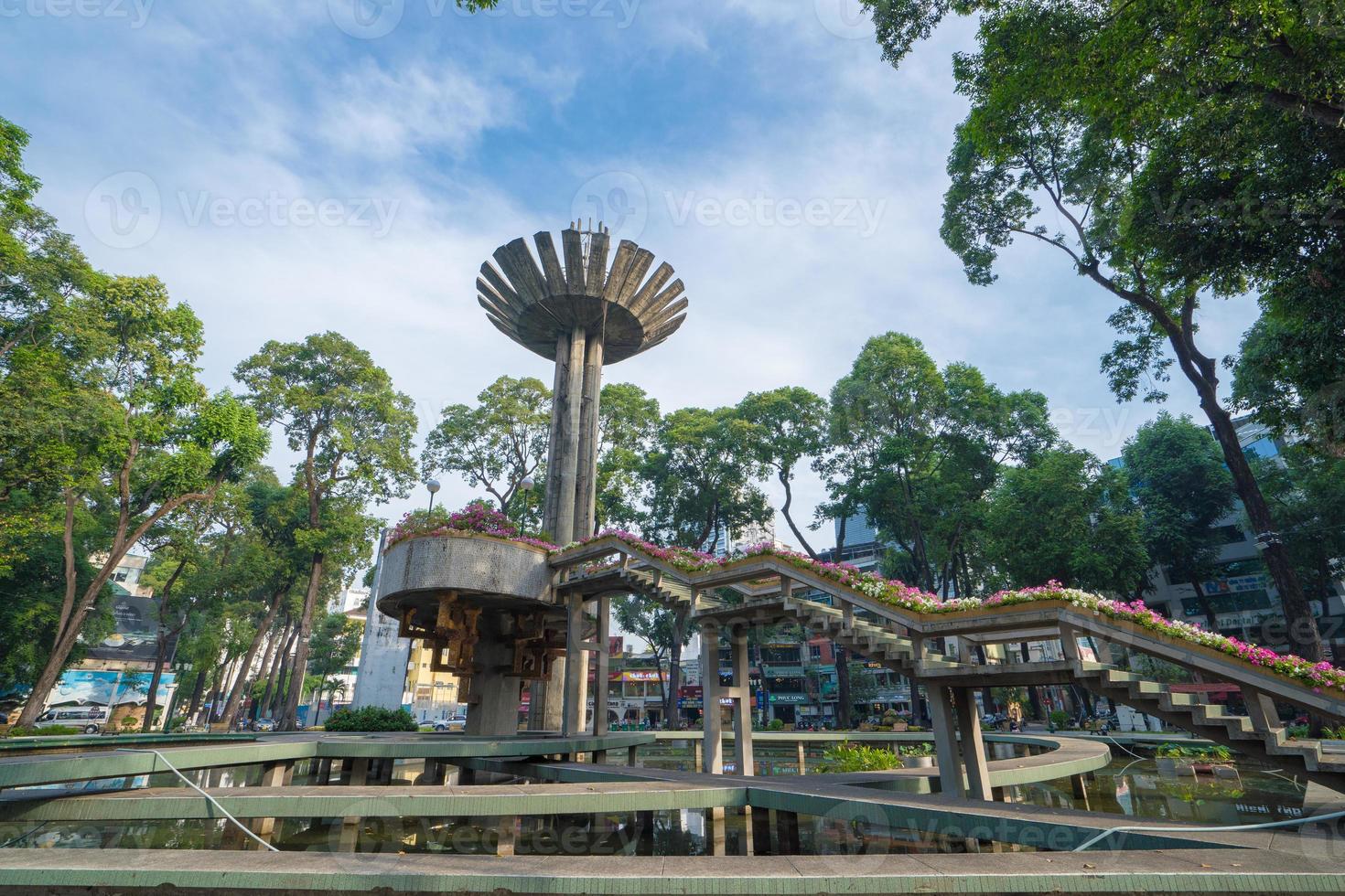 Wide angle view of Lotus pillar - An iconic architecture at Turtle lake , Ho Con Rua with blue sky in Saigon. photo