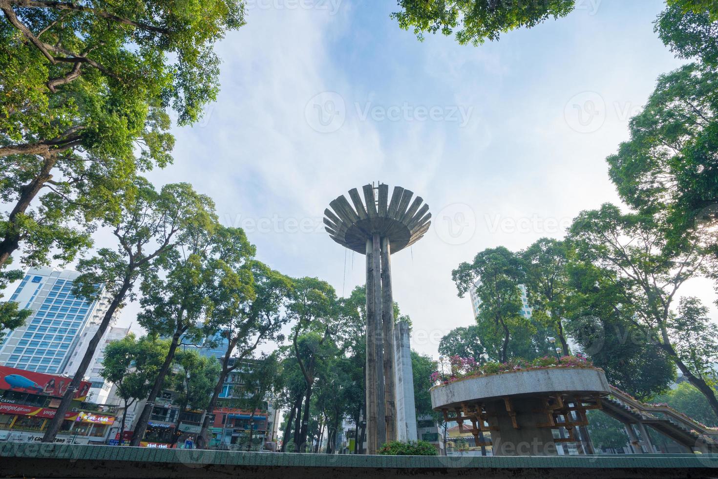 Wide angle view of Lotus pillar - An iconic architecture at Turtle lake , Ho Con Rua with blue sky in Saigon. photo