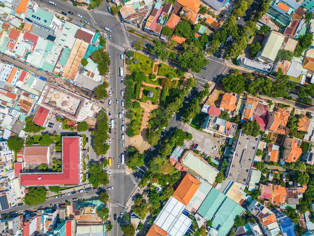 Vung Tau city aerial view with beautiful sunset and so many boats. Panoramic coastal Vung Tau view from above, with waves, coastline, streets, coconut trees and Tao Phung mountain in Vietnam. photo