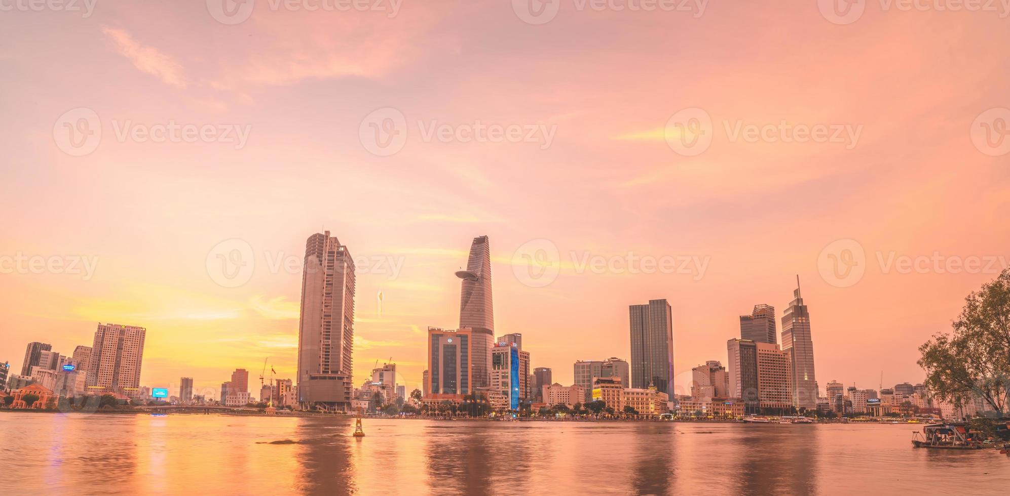 HO CHI MINH, VIETNAM - FEB 19 2022  View of Bitexco Financial Tower building, buildings, roads, Thu Thiem bridge and Saigon river in Ho Chi Minh city in sunset. High quality panorama image. photo