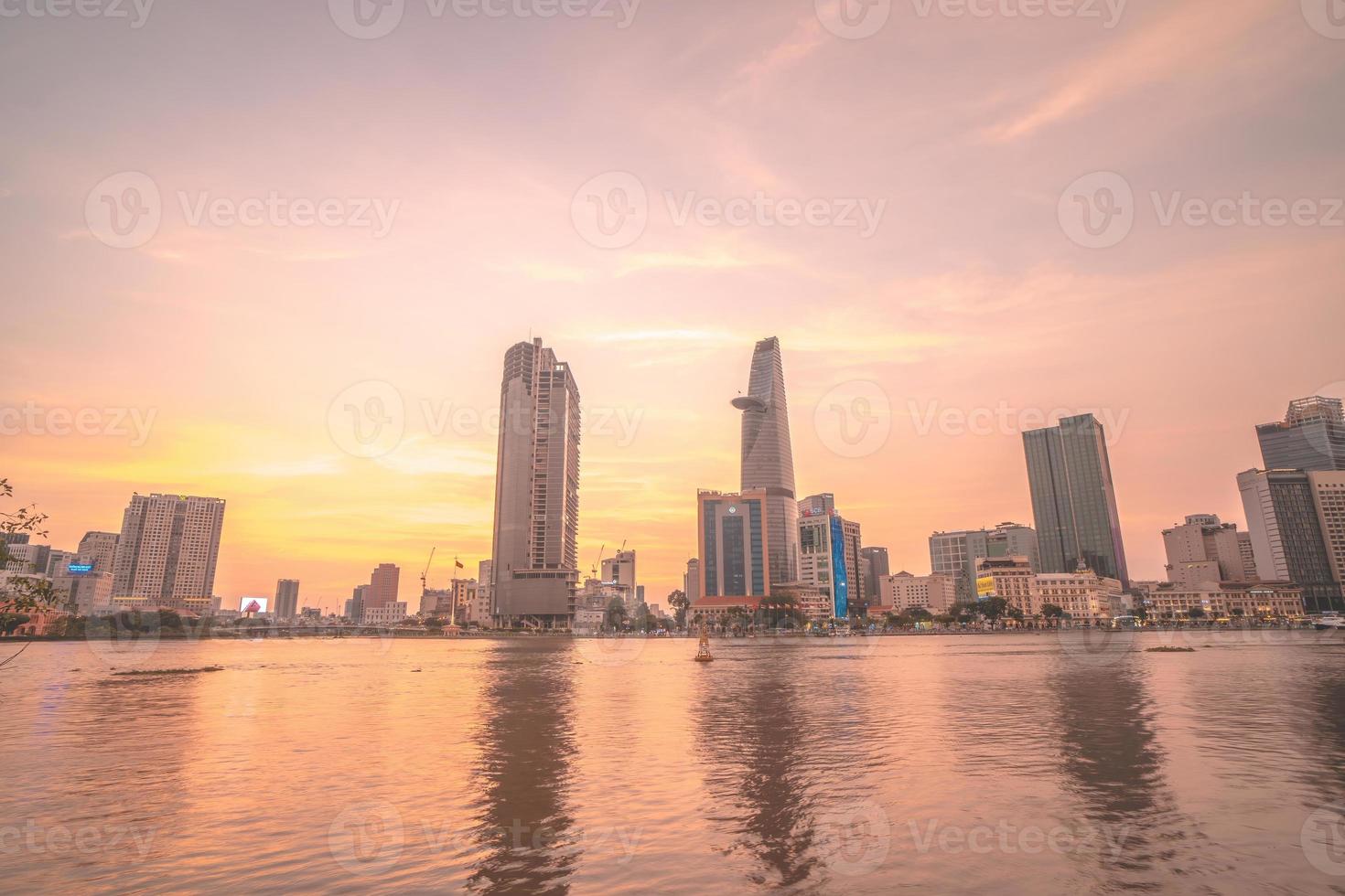 HO CHI MINH, VIETNAM - FEB 19 2022  View of Bitexco Financial Tower building, buildings, roads, Thu Thiem bridge and Saigon river in Ho Chi Minh city in sunset. High quality panorama image. photo