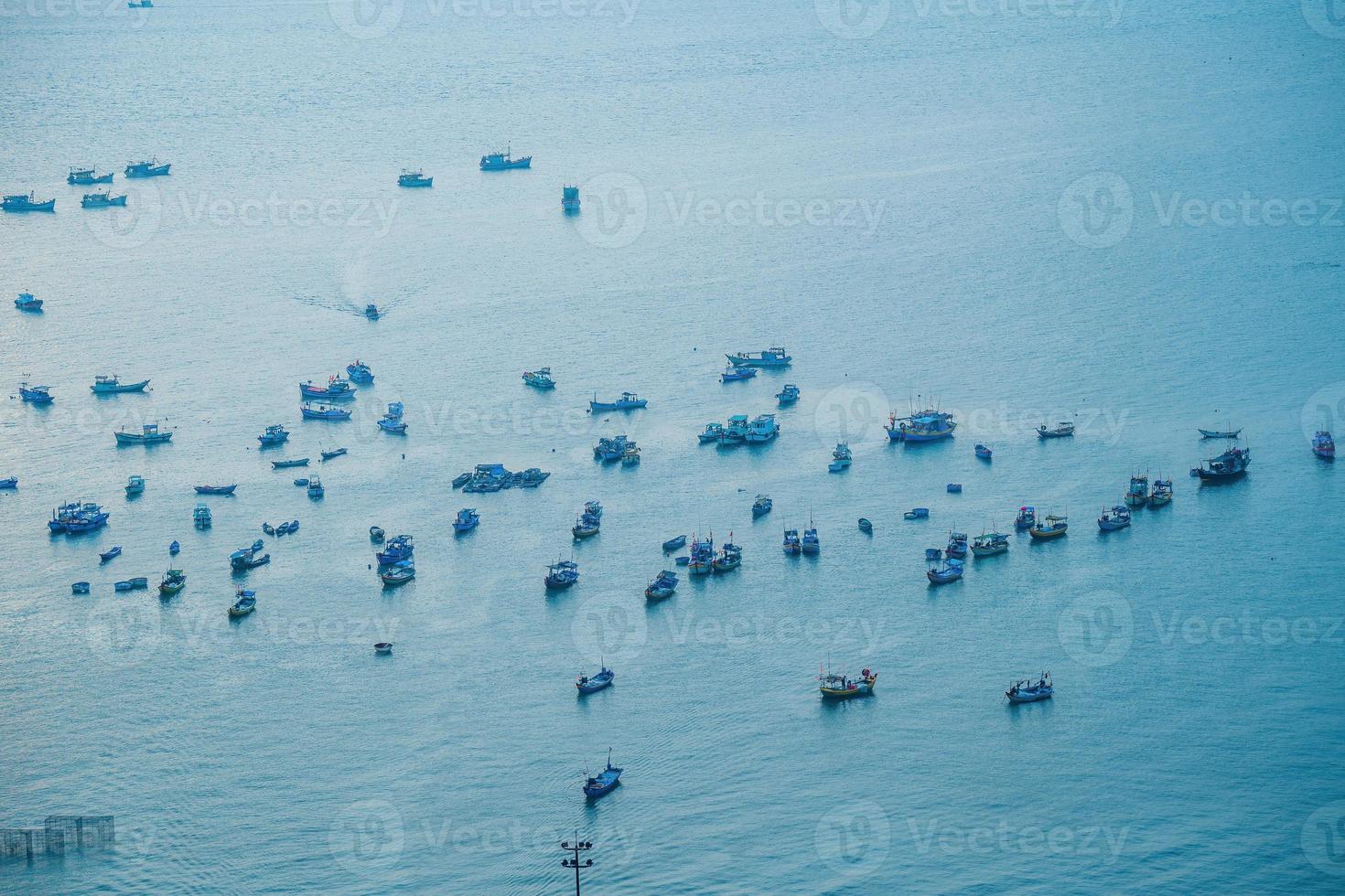 Aerial view many local culture Vietnam. Top view of local fisherman boats in the deep blue sea, tropical seascape. Travel destination Asia concept and background. photo