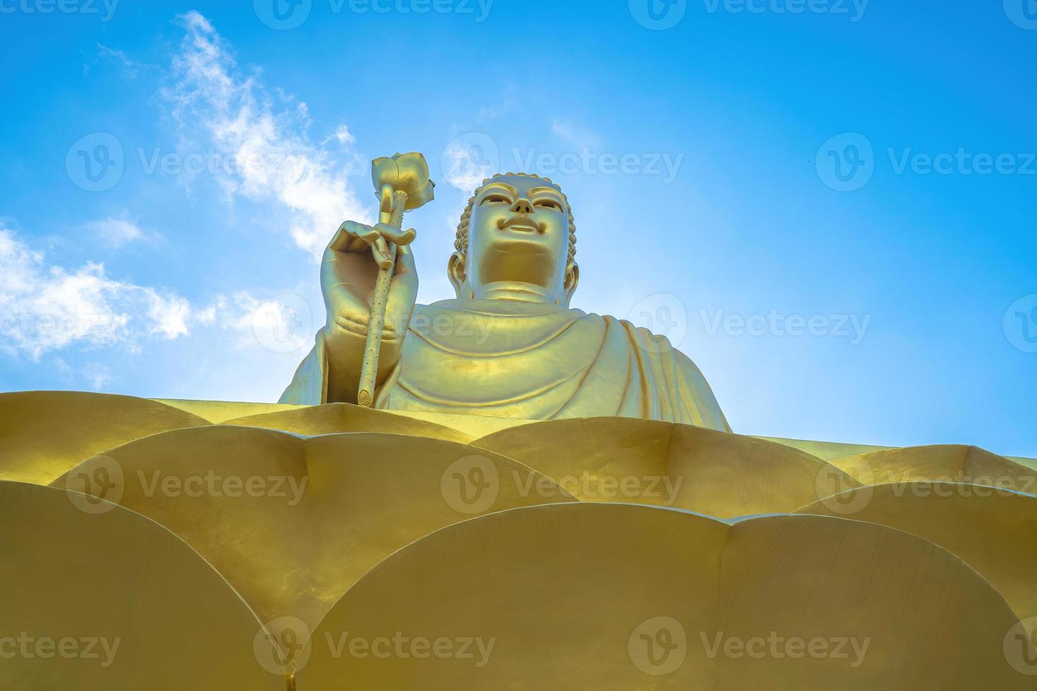 Golden Buddha statue's hand holding lotus at Chon Khong Monastery. photo