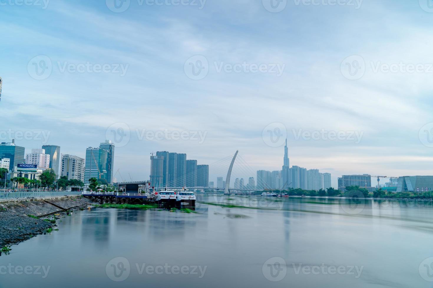 Ho Chi Minh city, Vietnam - FEB 12 2022 skyline with landmark 81 skyscraper, a new cable-stayed bridge is building connecting Thu Thiem peninsula and District 1 across the Saigon River. photo