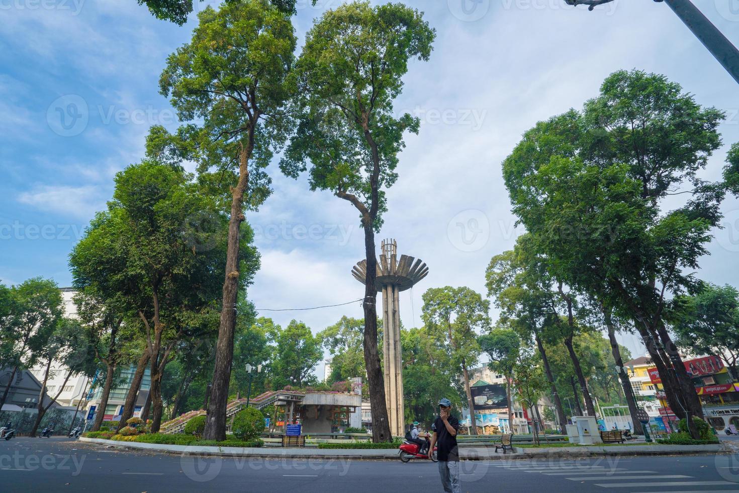 Wide angle view of Lotus pillar - An iconic architecture at Turtle lake , Ho Con Rua with blue sky in Saigon. photo