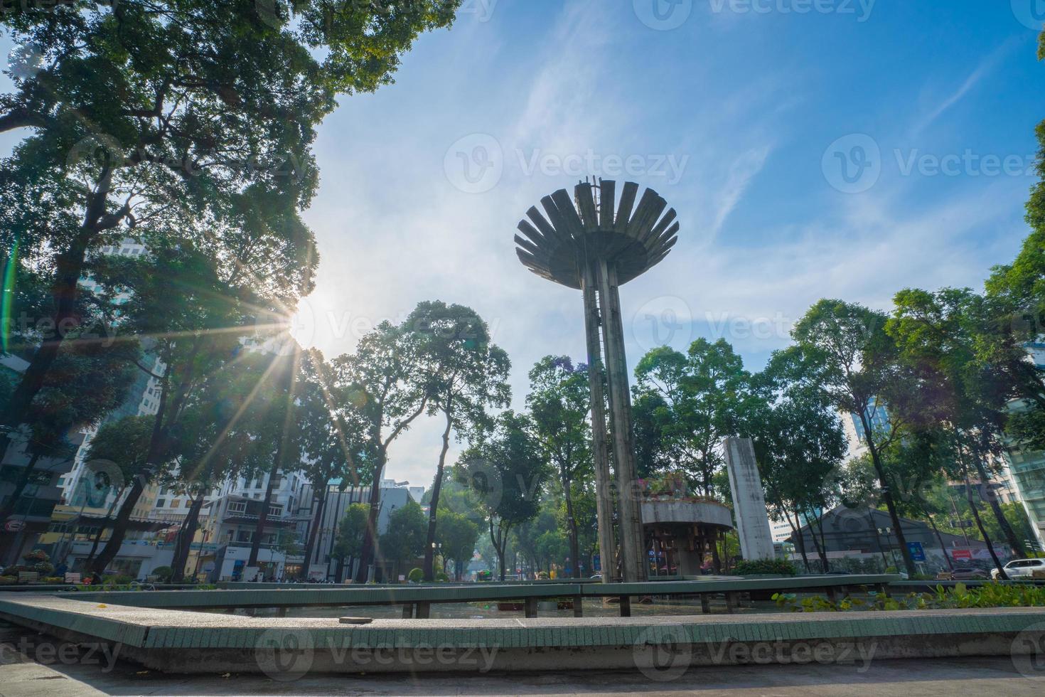 Wide angle view of Lotus pillar - An iconic architecture at Turtle lake , Ho Con Rua with blue sky in Saigon. photo