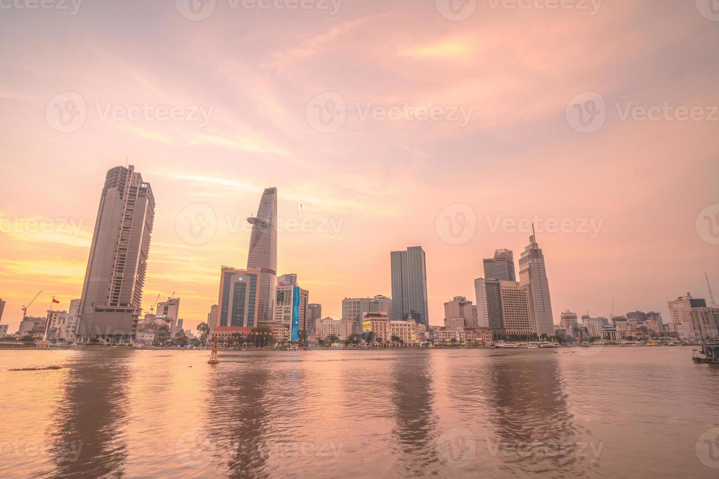 HO CHI MINH, VIETNAM - FEB 19 2022  View of Bitexco Financial Tower building, buildings, roads, Thu Thiem bridge and Saigon river in Ho Chi Minh city in sunset. High quality panorama image. photo