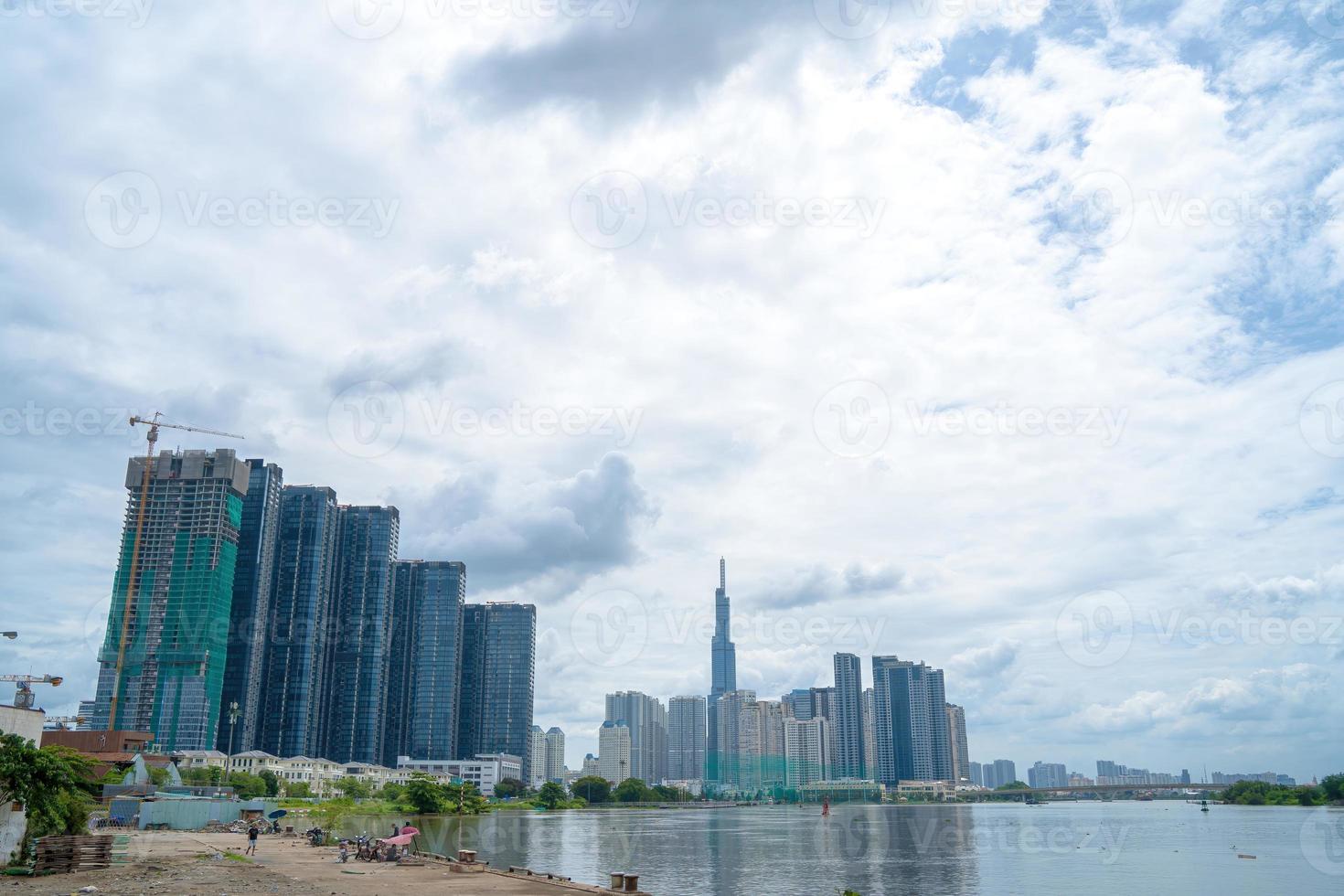 View at Landmark 81 - it is a super tall skyscraper and Saigon bridge with development buildings along Saigon river light smooth down photo