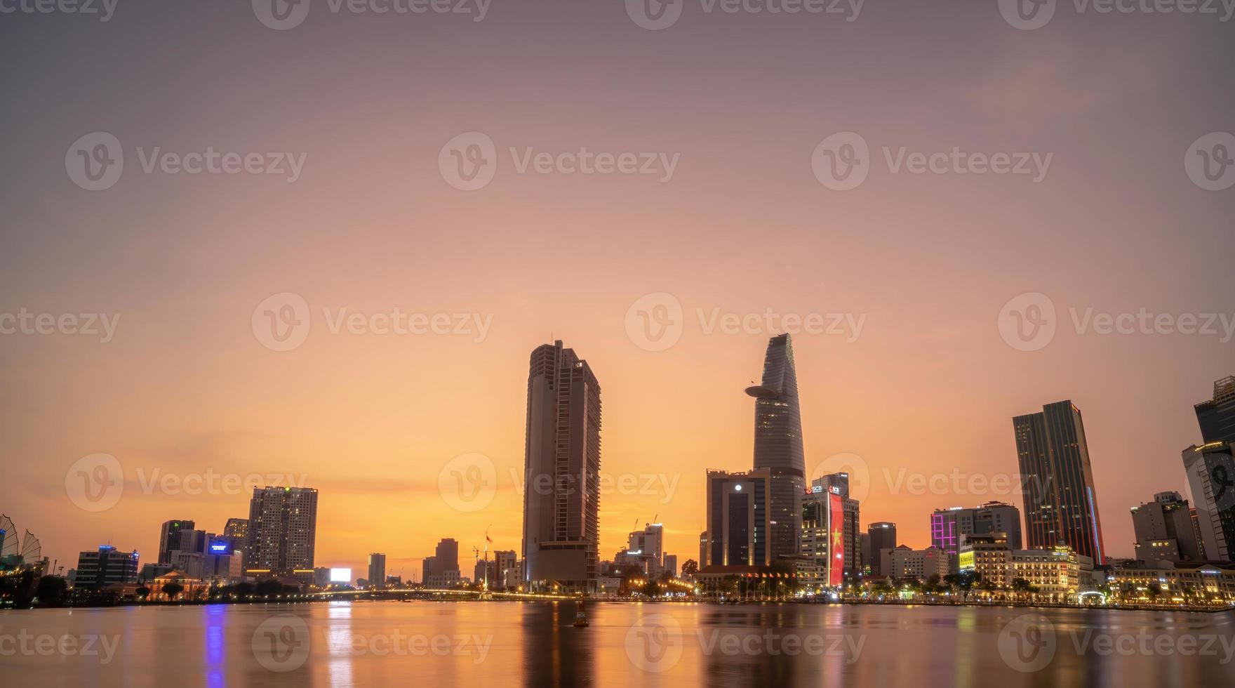 HO CHI MINH, VIETNAM - FEB 19 2022  View of Bitexco Financial Tower building, buildings, roads, Thu Thiem bridge and Saigon river in Ho Chi Minh city in sunset. High quality panorama image. photo