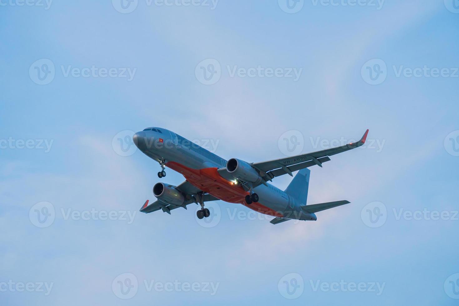 Ho Chi Minh city, Vietnam - FEB 20 2022 Airplane fly over urban areas preparing landing into Tan Son Nhat International Airport and takes off in TSN airport photo