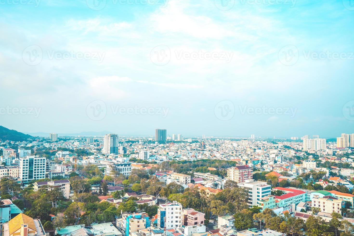 Vung Tau city aerial view with beautiful sunset and so many boats. Panoramic coastal Vung Tau view from above, with waves, coastline, streets, coconut trees and Tao Phung mountain in Vietnam. photo