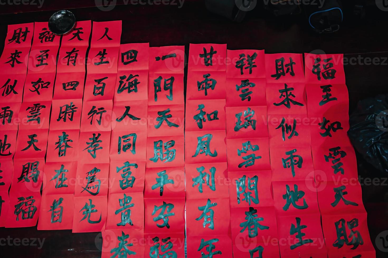 Vietnamese scholar writes calligraphy at Long Son. Calligraphy festival is a popular tradition during Tet holiday. Writing couplets for Spring Festival, new year. photo