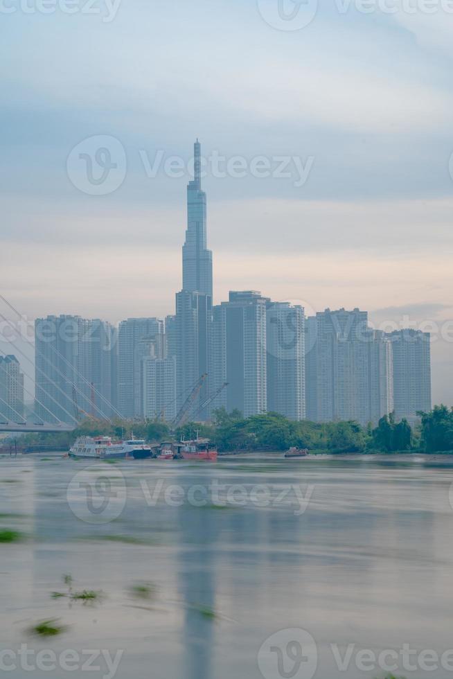 Ho Chi Minh city, Vietnam - FEB 12 2022 skyline with landmark 81 skyscraper, a new cable-stayed bridge is building connecting Thu Thiem peninsula and District 1 across the Saigon River. photo