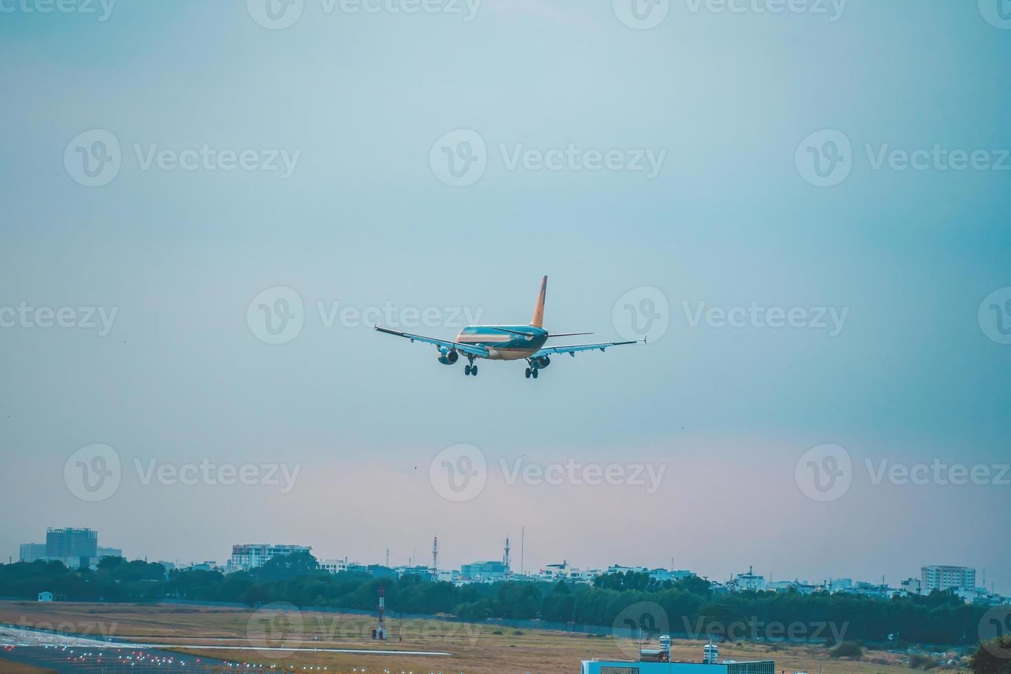 Ho Chi Minh city, Vietnam - FEB 12 2022 Airplane fly over urban areas preparing landing into Tan Son Nhat International Airport and takes off in TSN airport photo
