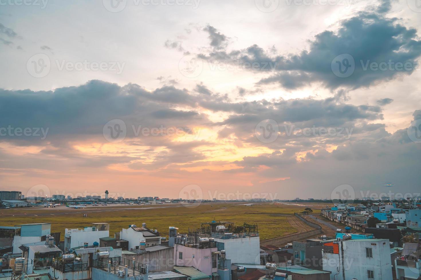 Ho Chi Minh city, Vietnam - FEB 12 2022 Airplane fly over urban areas preparing landing into Tan Son Nhat International Airport and takes off in TSN airport photo