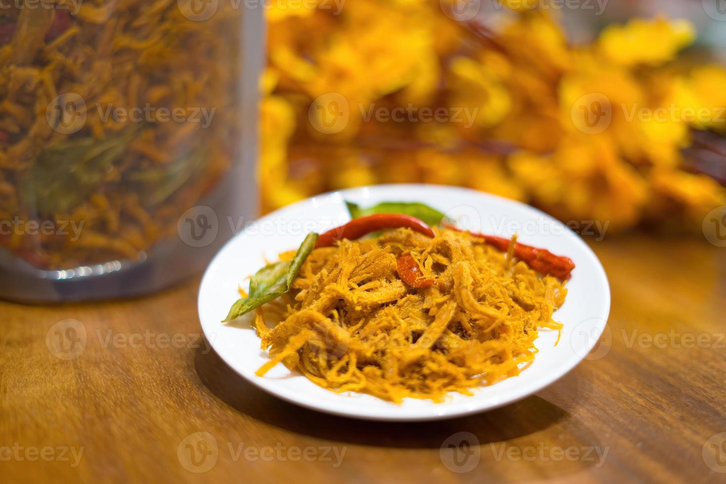 Kho Ga, Spicy Dried Chicken the Vietnamese snacks made from chicken meat with some chilly, lemon leaf and dried onion photo