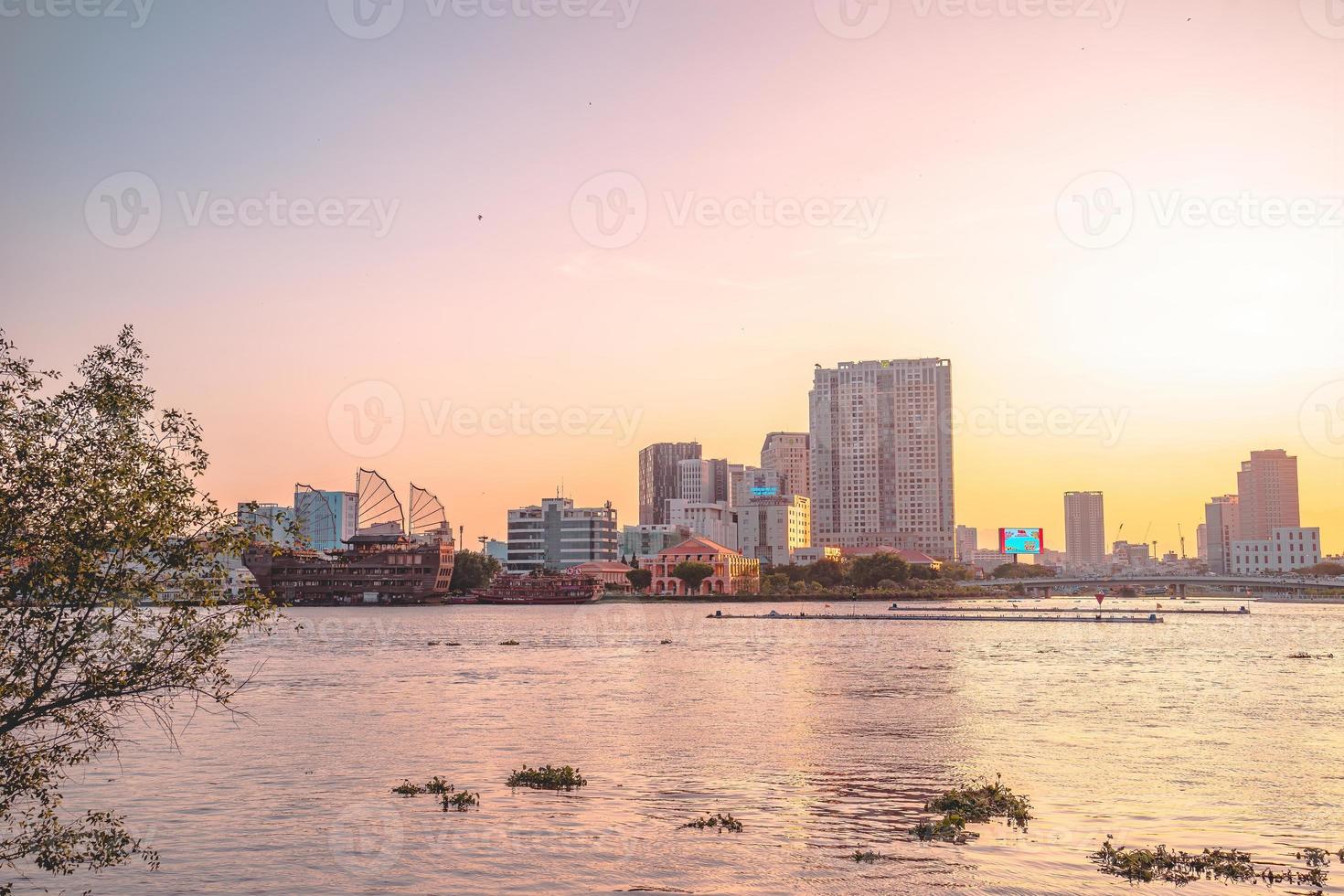 HO CHI MINH, VIETNAM - FEB 13 2022  View of Bitexco Financial Tower building, buildings, roads, Thu Thiem bridge and Saigon river in Ho Chi Minh city in sunset. High quality panorama image. photo