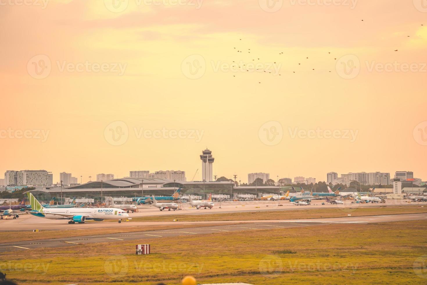 Ho Chi Minh city, Vietnam - FEB 12 2022 Airplane fly over urban areas preparing landing into Tan Son Nhat International Airport and takes off in TSN airport photo