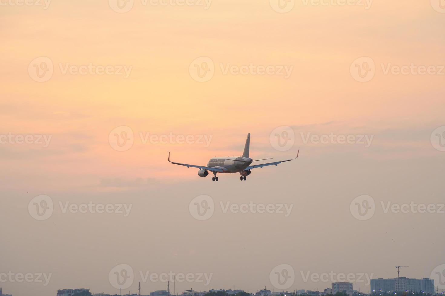 Ho Chi Minh city, Vietnam - FEB 20 2022 Airplane fly over urban areas preparing landing into Tan Son Nhat International Airport and takes off in TSN airport photo